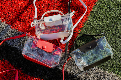 Clear and transparent bags with colorful accents on a football field.