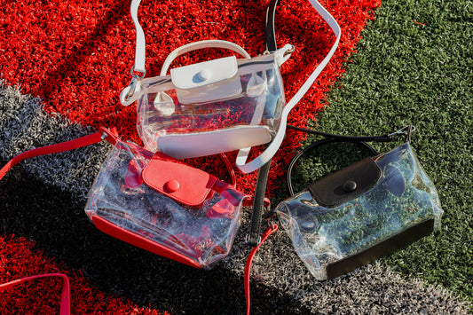 Clear and transparent bags with colorful accents on a football field.