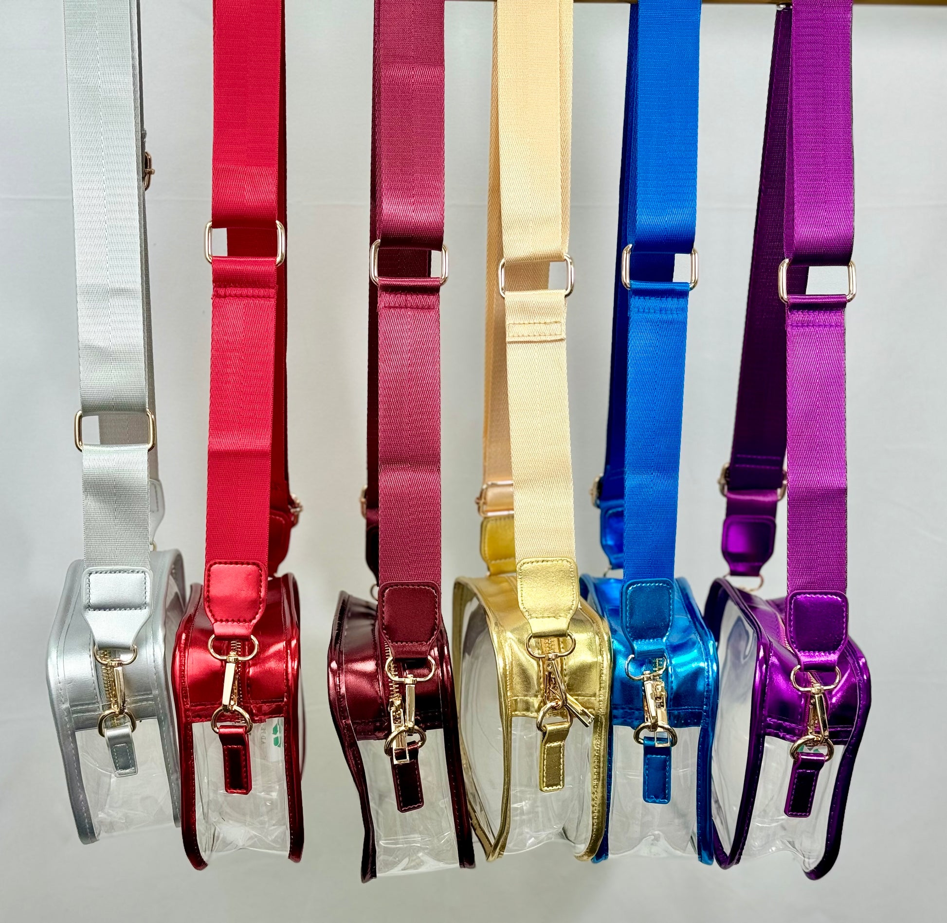 Set of colorful metallic stadium purses in various colors on a white background